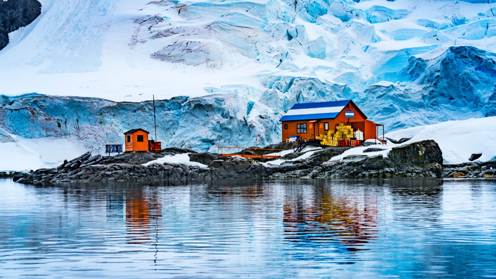 Snowing Argentine Almirante Brown Station Blue Glacier Mountain Paradise Harbor Bay Antarctic Peninsula Antarctica. Glacier ice blue because air squeezed out of snow.