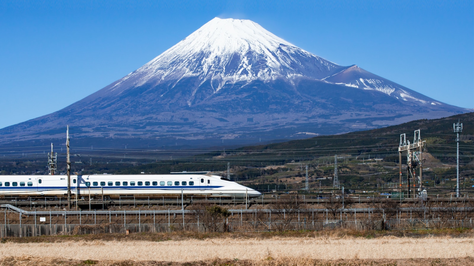 Japan - January 3, 2020 : High Speed Bullet Train Shinkansen passing Fuji Mountain at Fuji City in Winter, Shizuoka