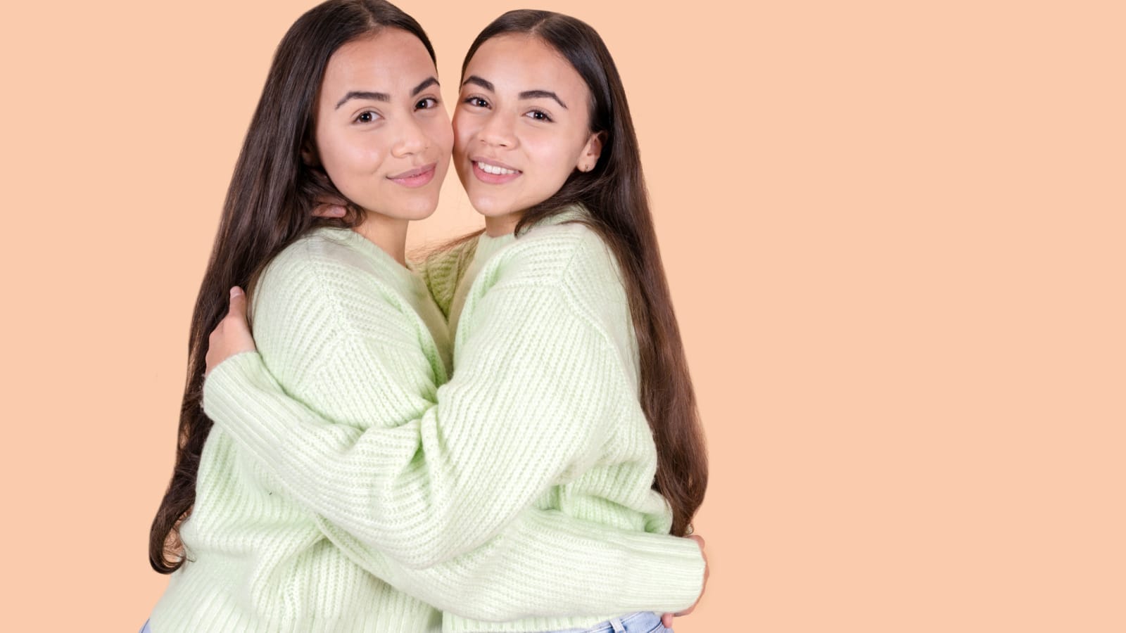 concept of twin sisters embracing. Family relationships, portrait of twin sisters.