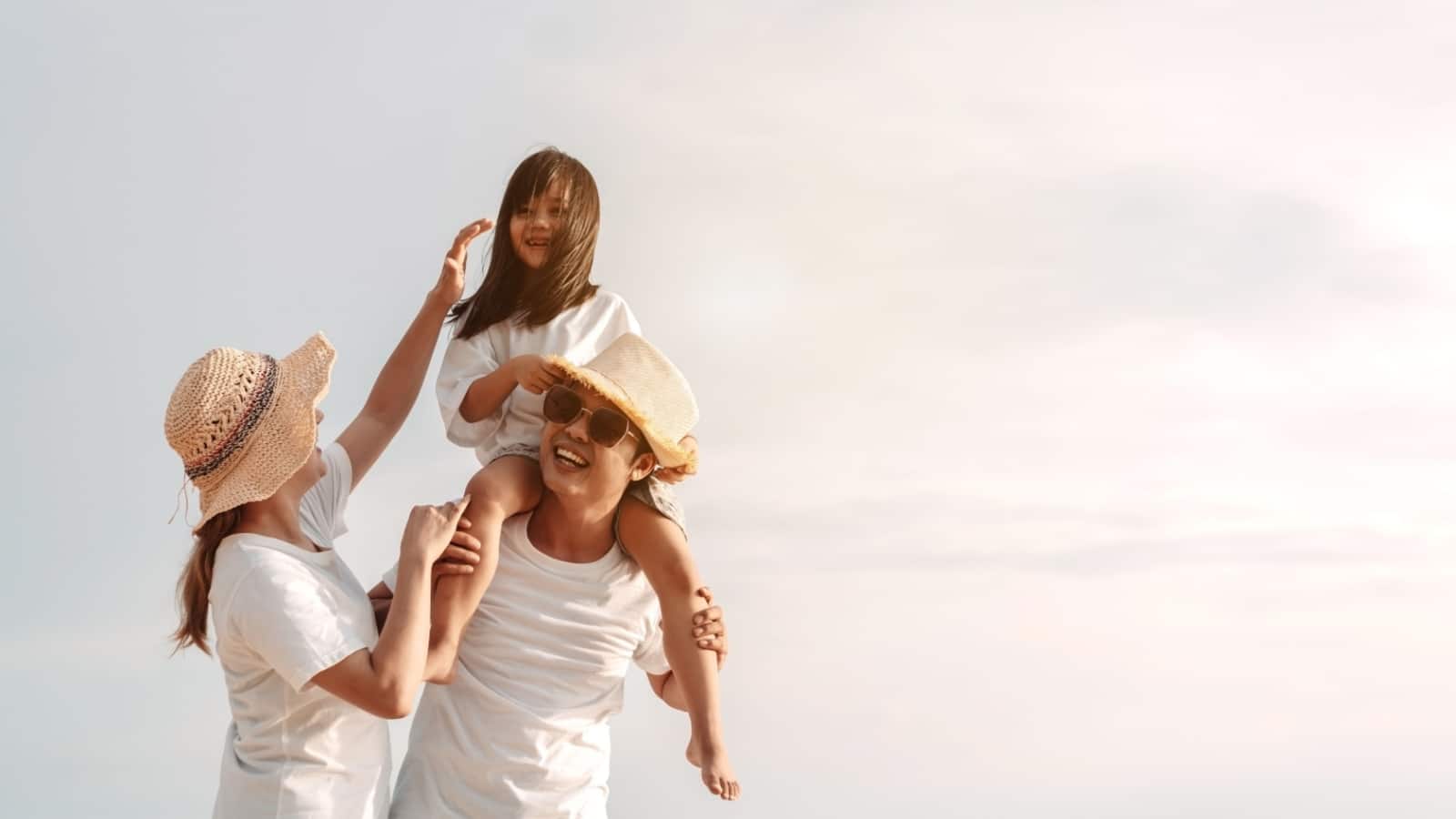 Happy asian family enjoy the sea beach. father, mother and daughter having fun playing beach in summer vacation on the ocean beach. Happy family with vacation time lifestyle concept
