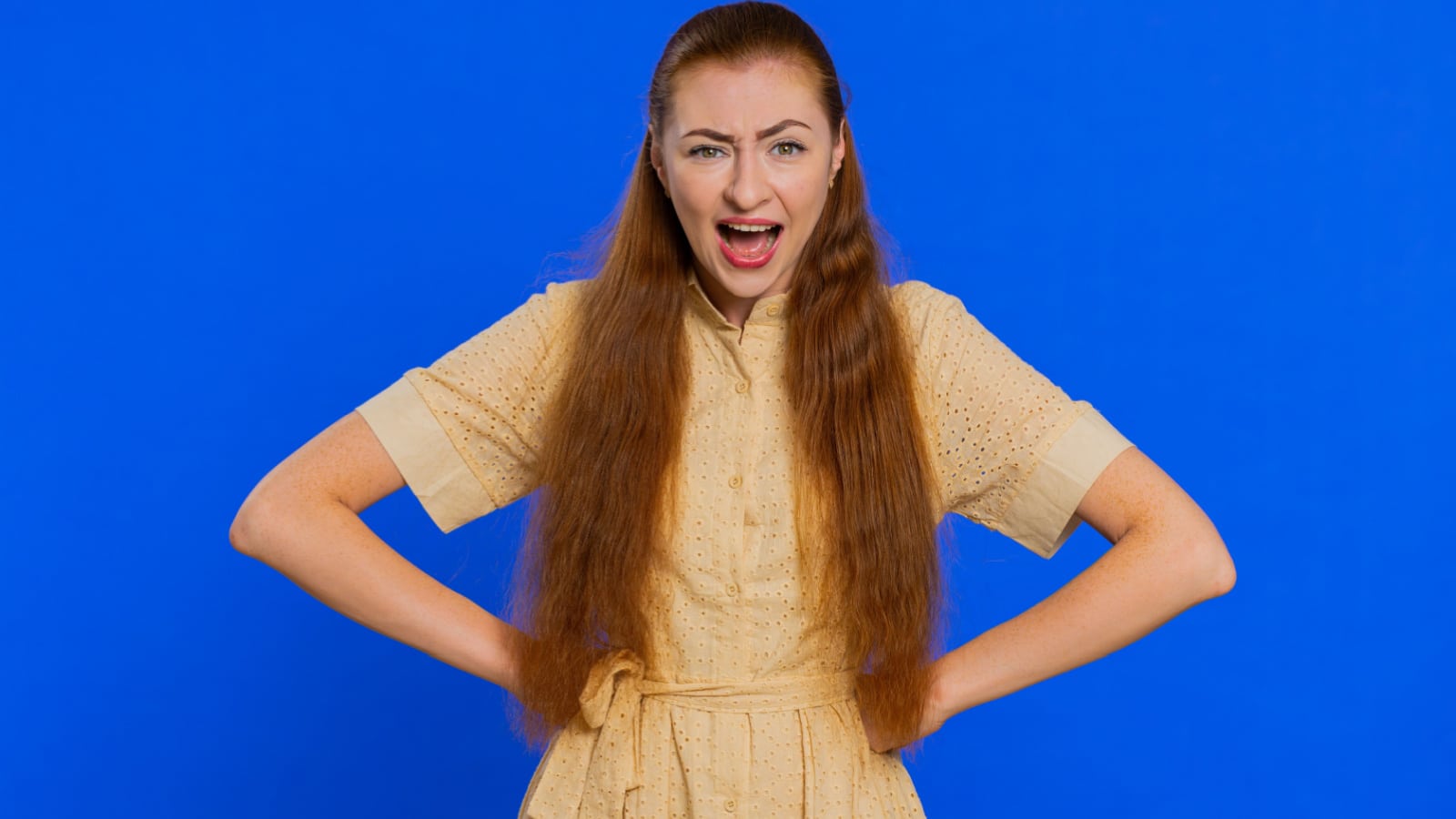 Offended sad nervous woman having misunderstanding, frustrated after quarrel, fail, lose, ignores and does not want to communicate, talk. Redhead girl isolated on blue background. People lifestyles