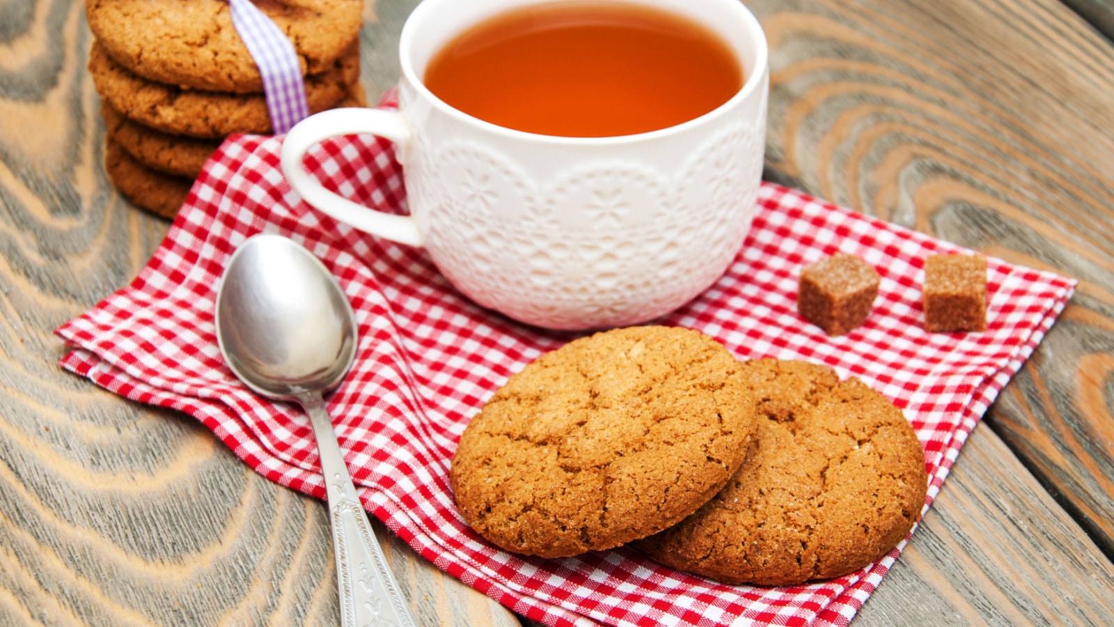Cup of tea with oatmeal cookies on a wooden background