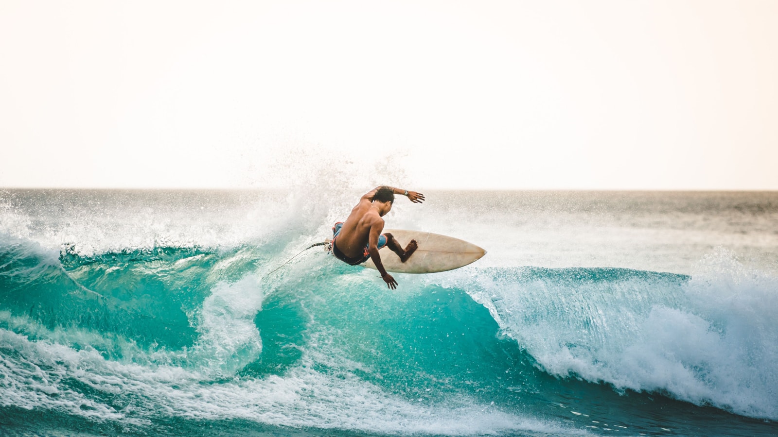 professional surfer riding waves in Bali, Indonesia. men catching waves in ocean, isolated. Surfing action water board sport. people water sport lessons and beach swimming activity on summer vacation