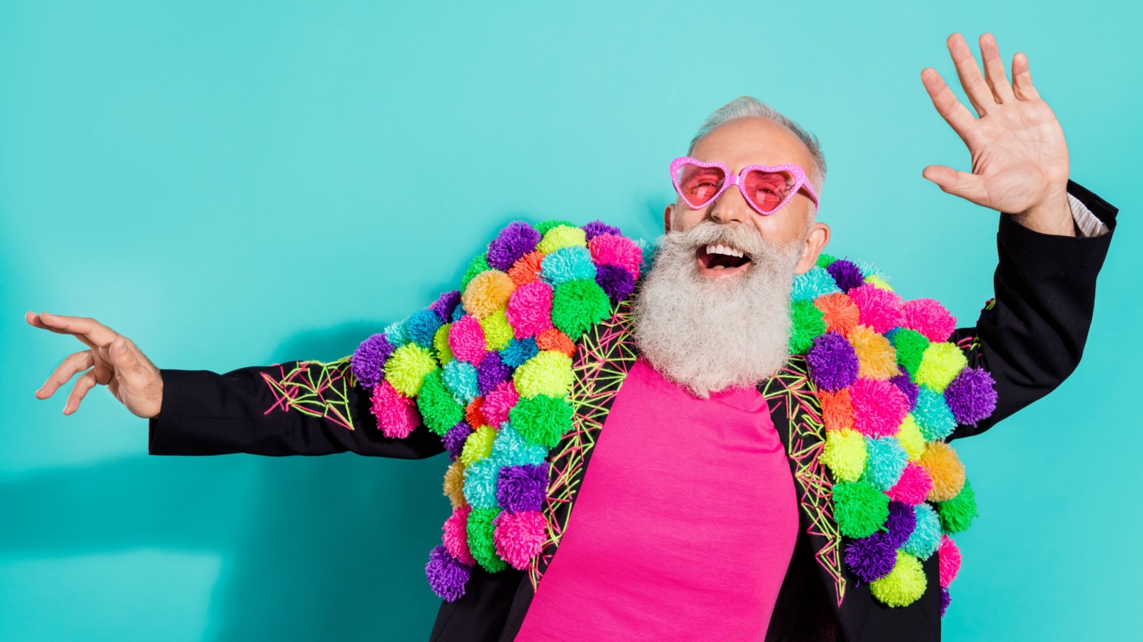 Photo of funny excited mature guy dressed craft pom-pom jacket eyewear smiling dancing isolated turquoise color background