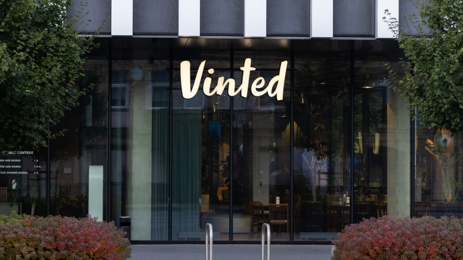 Vilnius, Lithuania - September 25, 2022: Vinted logo sign on main office, headquarters building wall. Vinted is online marketplace for second hand clothing, Unicorn startup