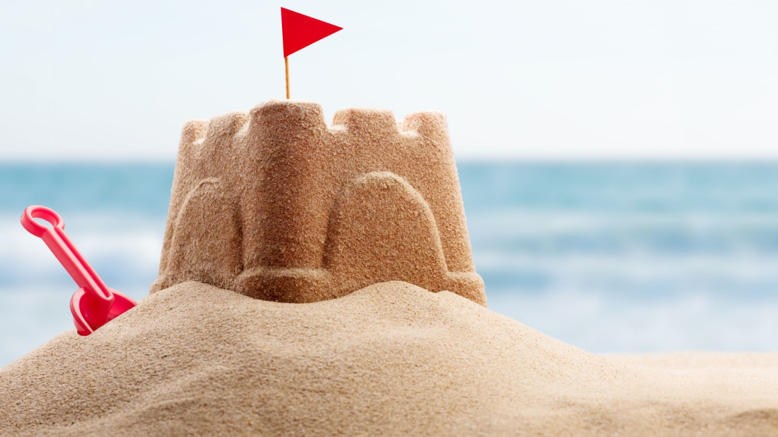 Holiday concept with sandcastle on the seaside