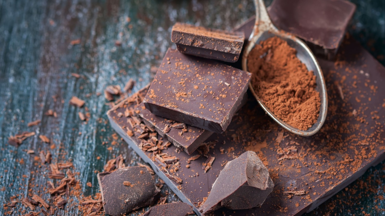 dark chocolate over wooden background, selective focus