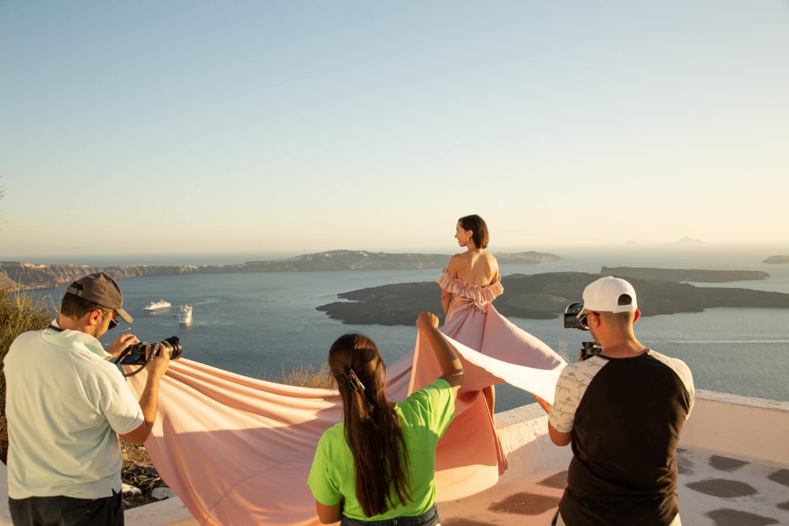 Everyone helping Lindsey and holding her pink dress during the flying dress photoshoot a behind the scenes look