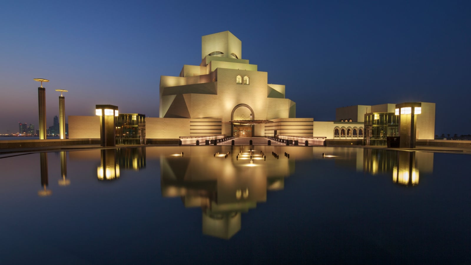 Museum of Islamic Art , Doha,Qatar in daylight exterior view with fountain in foreground and clouds in the sky in the background