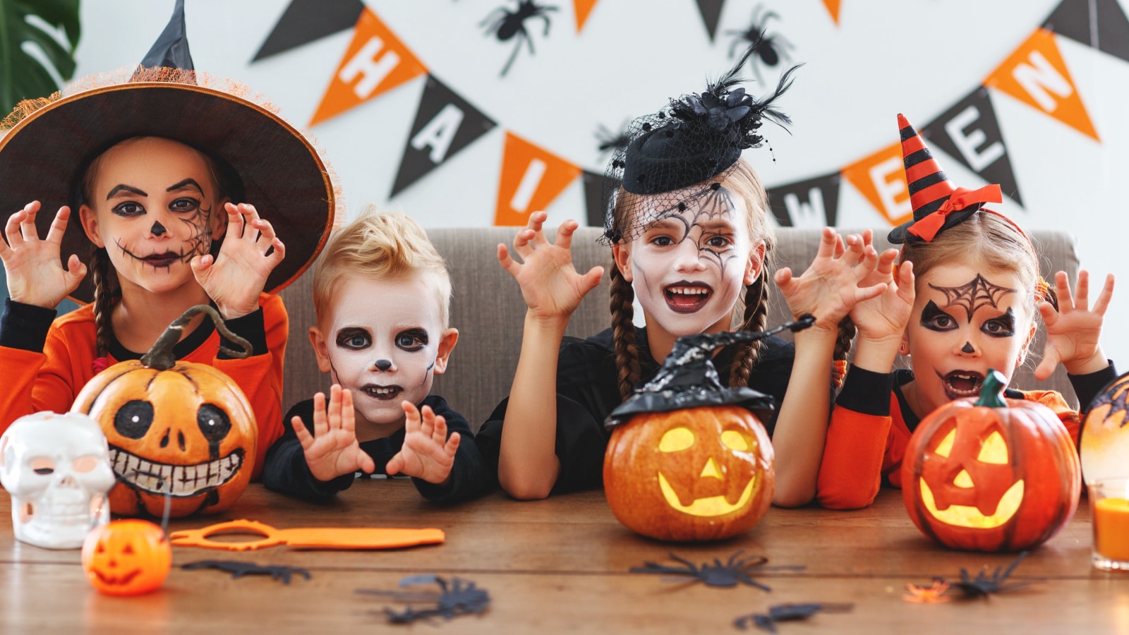 happy Halloween! a group of children in suits and with pumpkins in the home