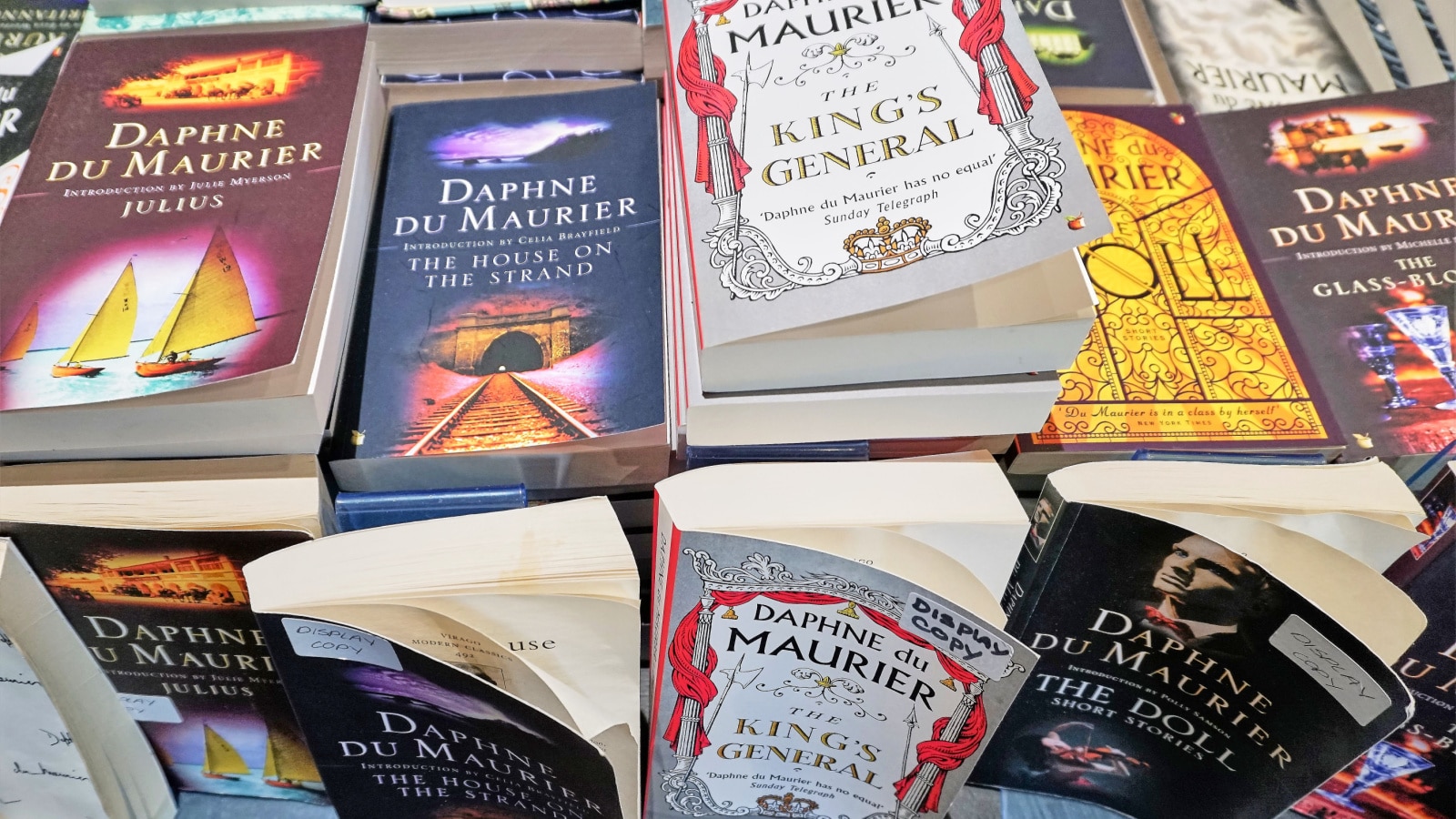 Jamaica Inn, Cornwall, England - Aug 2017: Close up of a pile of Daphne Du Maurier paperback books for sale.