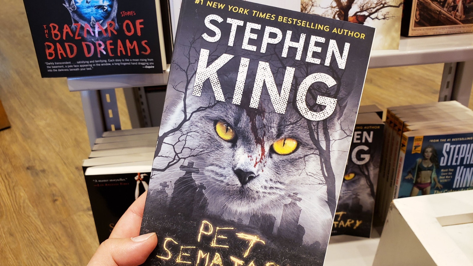 Montreal, Canada - October 23, 2019: A hand holding a Stephen King book Pet Sematary. Stephen King is an American famous author of supernatural fiction, horror and fantasy novels.