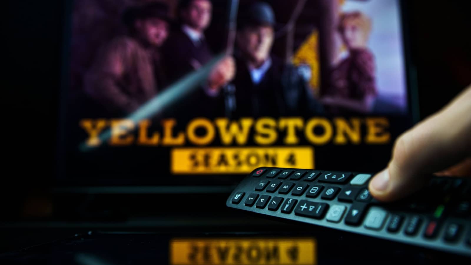 Vilnius, Lithuania - 2021 November 21: TV series Yellowstone and TV remote controler. TV show Yellowstone is made by Paramount Network