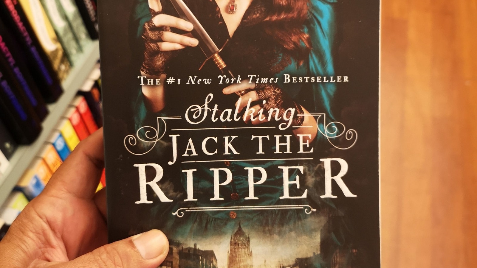 Kuala Lumpur, Malaysia - 17 December 2021 : Hand hold a book title STALKING JACK THE RIPPER written by KERRI MANISCALCO for sell in the book stores with selective focus.