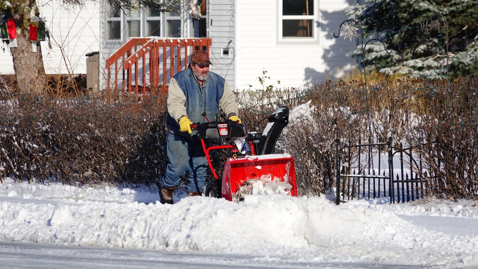 Mauston, Wisconsin USA - December 20th, 2021: Community members use snow plows to plow the snow from the sidewalks.