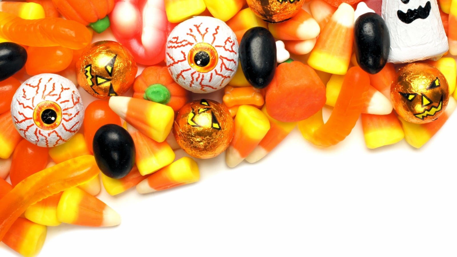 Halloween candy corner border over a white background
