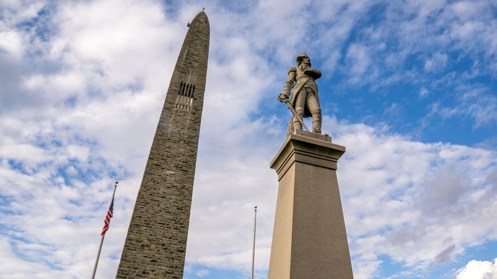 Bennington, VT - USA - Oct 10, 2022 View of the Statue of Seth Warner in front of Bennington Battle Monument. The monument commemorates the Battle of Bennington during the American Revolutionary War.