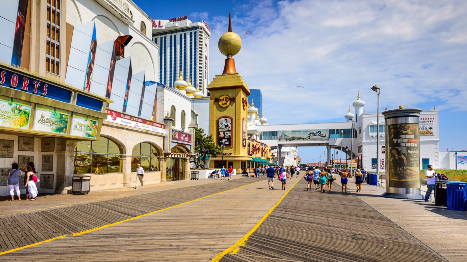 ATLANTIC CITY, NEW JERSEY - SEPTEMBER 9, 2012: Tourists walk on the boardwalk in Atlantic City.