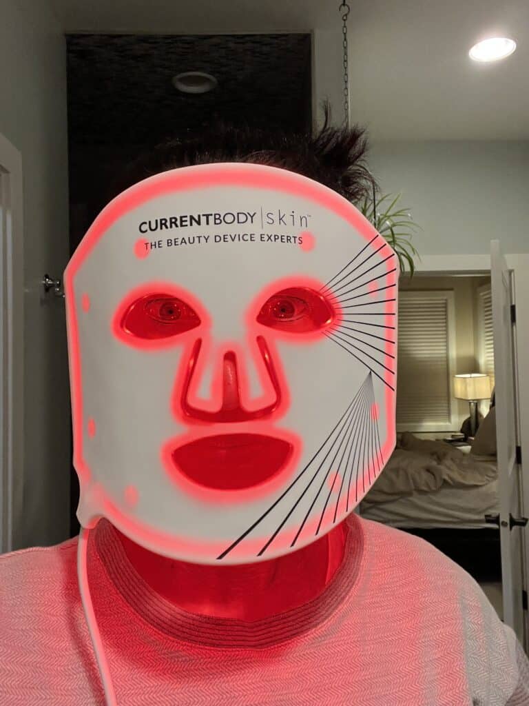 Lindsey of Have Clothes, WIll Travel wearing the CurrentBody LED Face mask in her bathroom