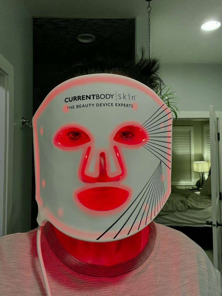 Lindsey of Have Clothes, WIll Travel wearing the CurrentBody LED Face mask in her bathroom