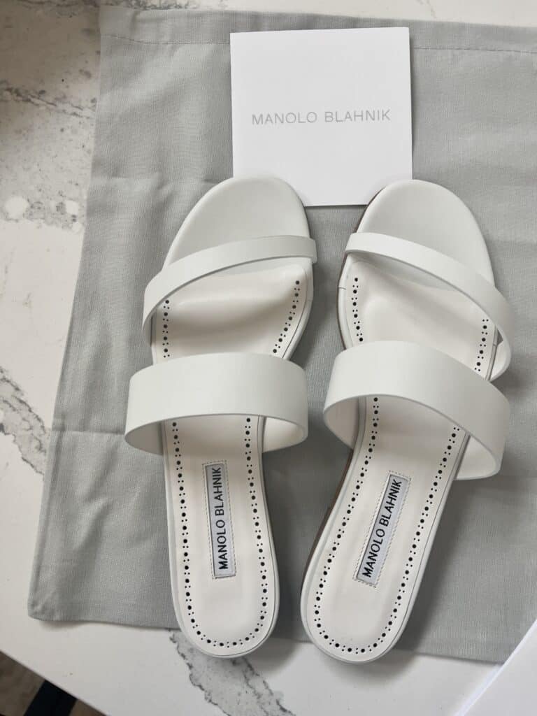 my white Manolo Blahnik sandals on a dust cover with authenticity papers