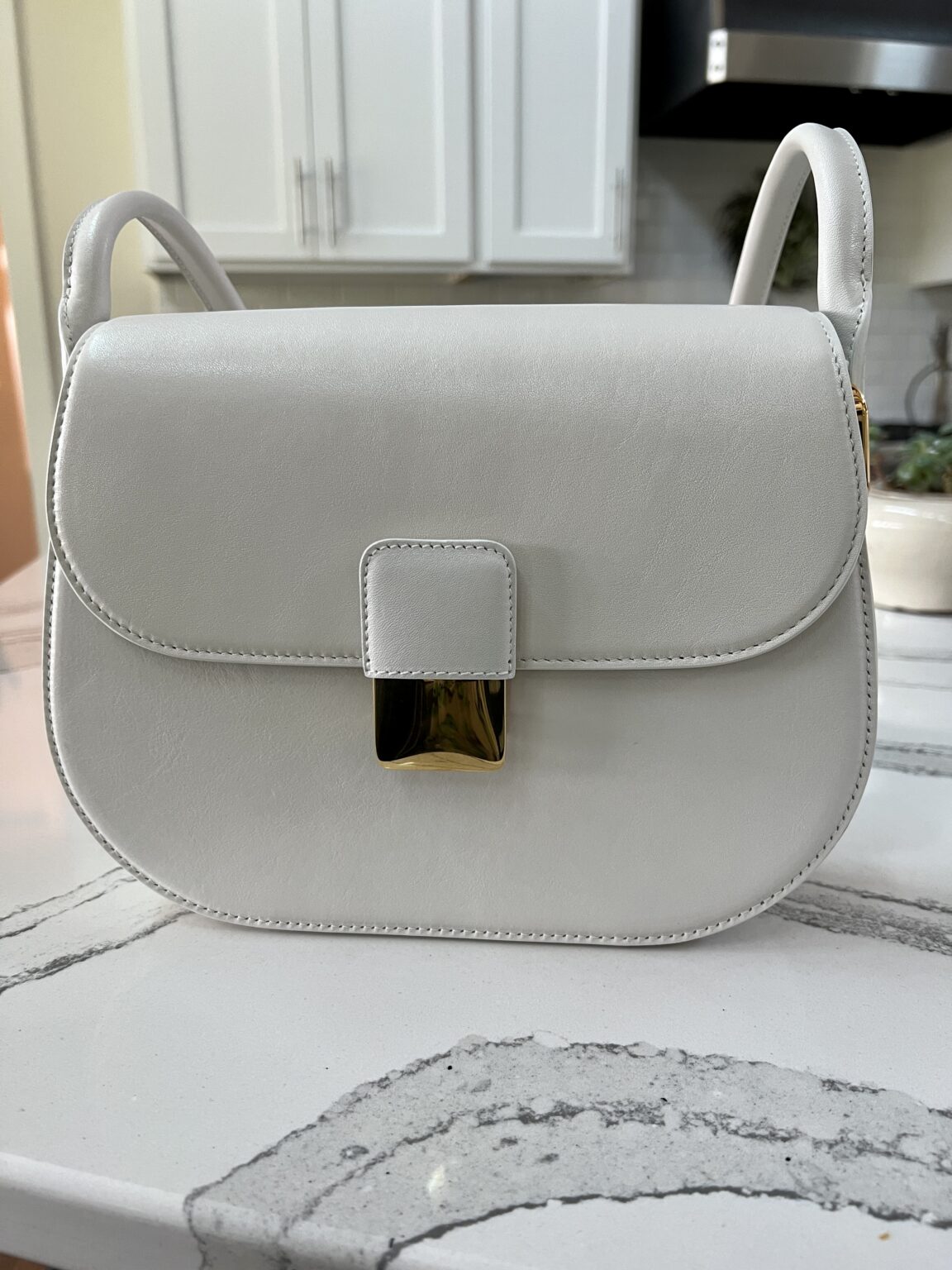 Bottega Veneta small Desiree bag sitting on a white countertop 