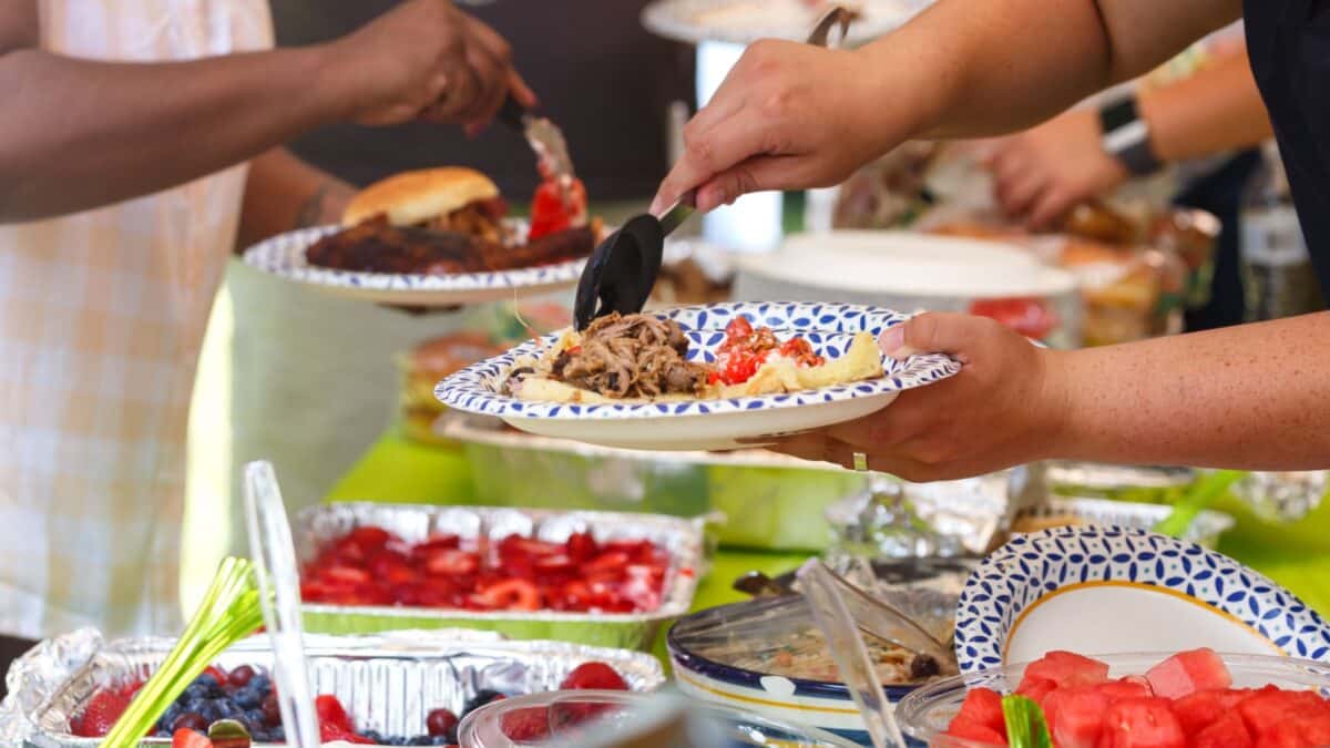 People sharing food at a summer potluck event