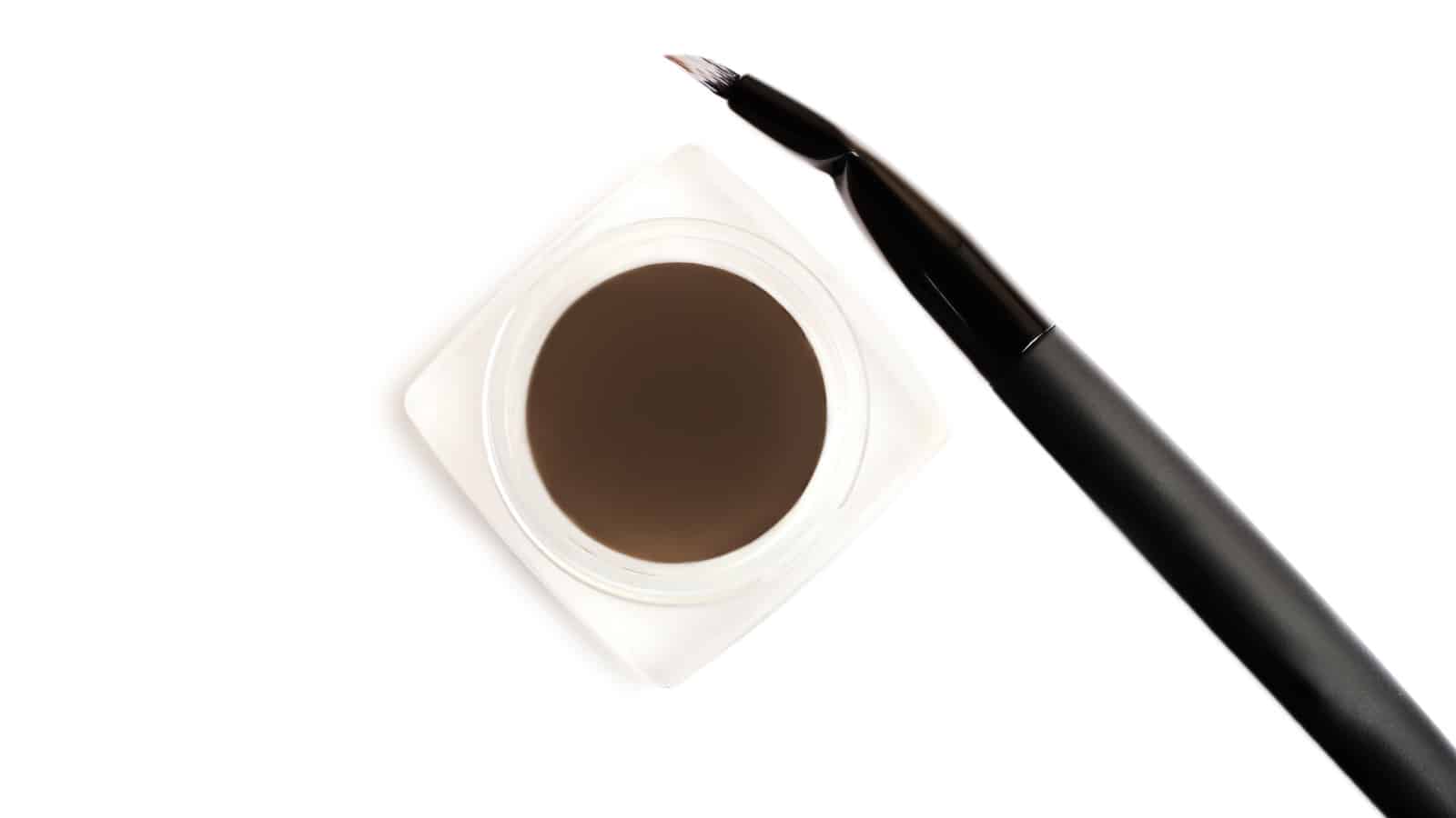 Dark brown dipbrow pomade with special brush.Eyebrow cosmetics.Make up concept.Isolated on white.