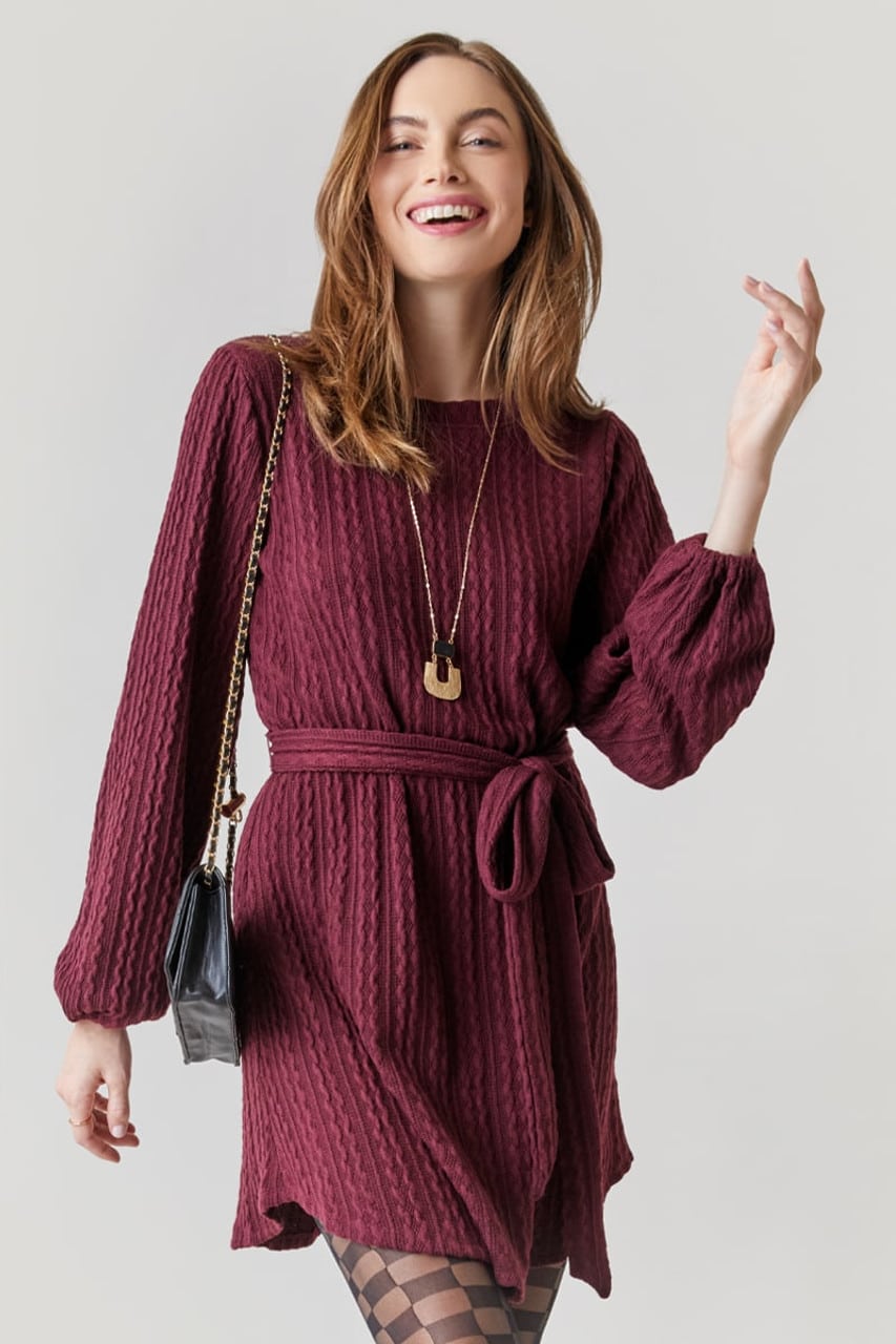 Shelby Textured Sweater Dress in Burgundy it is a mini length with long sleeves and a tie belt