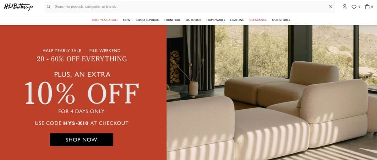 HD Buttercup website with 10% off sale and cream sectional sofa with floor to ceiling windows