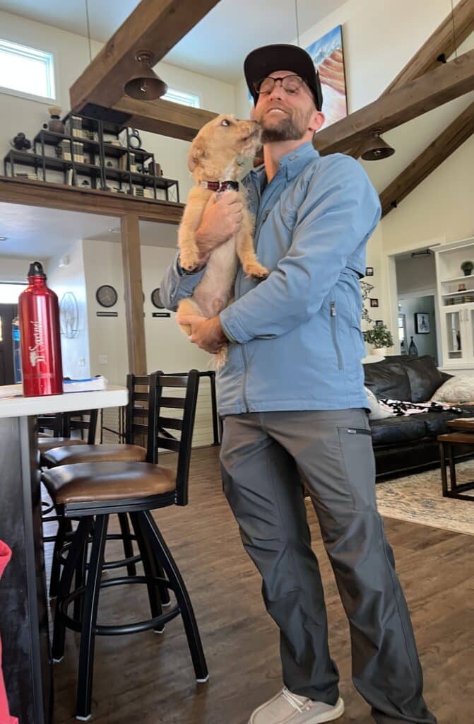 Zac wearing a SCOTTeVEST outfit and holding buddy