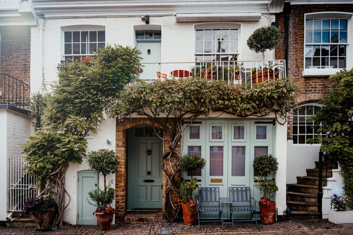 Neighborhood district Knightsbridge Kensington or Chelsea cute private mews alley road street with plants decorations. London. October 2022