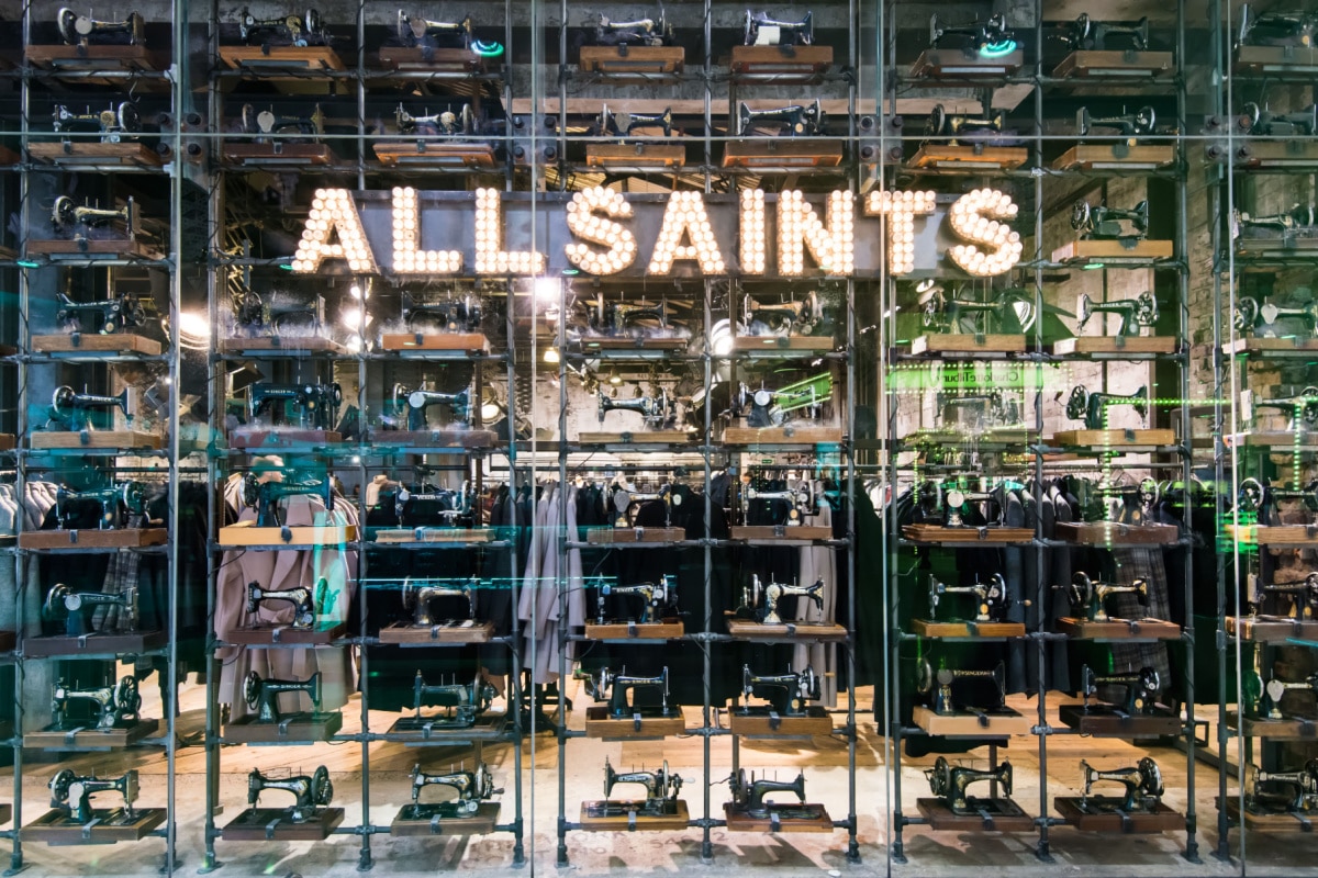 LONDON,ENGLAND-NOVEMBER 19,2016:The main window, full of old fashioned sewing machines, of the All Saints store on Westfield shop centre London.AllSaints is a British fashion retailer headquartered.
