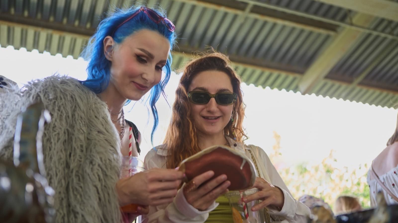 Women choosing ceramicware in thrift shop