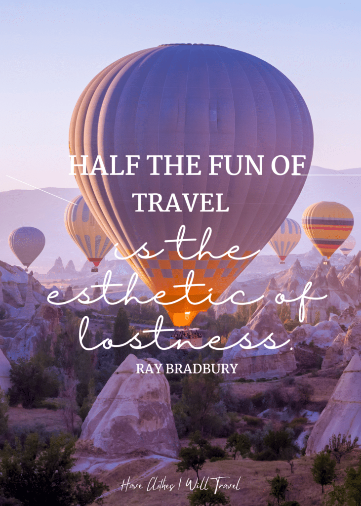 Colorful shot of giant hot air balloons in flight as background for a travel quote by Ray Bradbury 