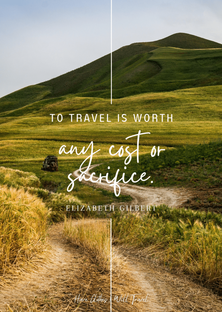 Portrait shot of an open green field with  a valley and dirt road as background for a travel quote by Elizabeth Gilbert