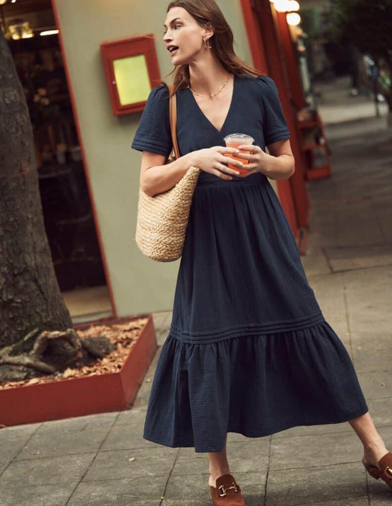 Model Wearing one of the Best Cottagecore Dresses - the Eve Double Cloth Midi Dress in Navy Blue from BODEN