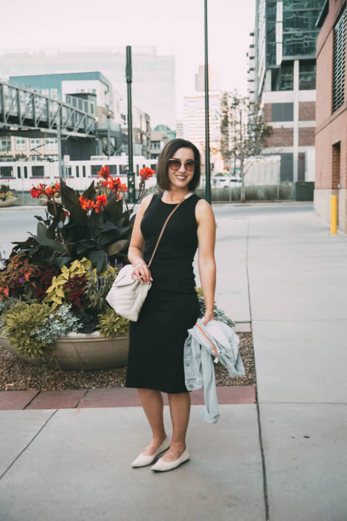 Lindsey wearing a black Tentree dress, YSL cream loulou bag, and cream Vivaia flats in Denver during summer