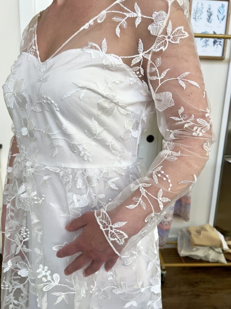 A closeup of the sleeve of the wedding dress