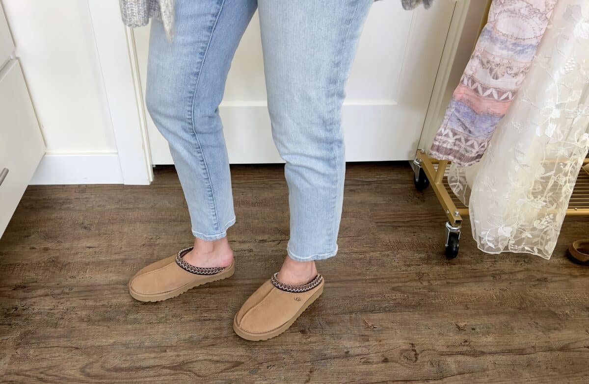 Lindsey wearing her slippers with jeans, her feet are hanging off the end of them because they are too small