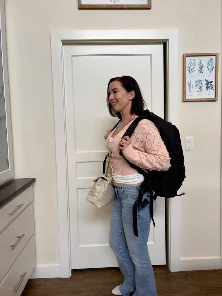 Lindsey wearing a backpack and YSL loulou as a crossbody