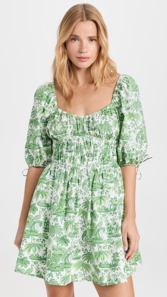 Model Wearing one of the Best Cottagecore Dresses - a Green Mini Floral Dress from STAUD