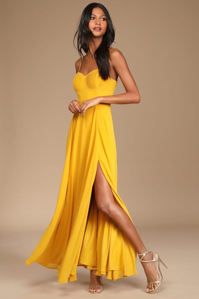 Woman modeling a long mustard yellow dress from Lulu's