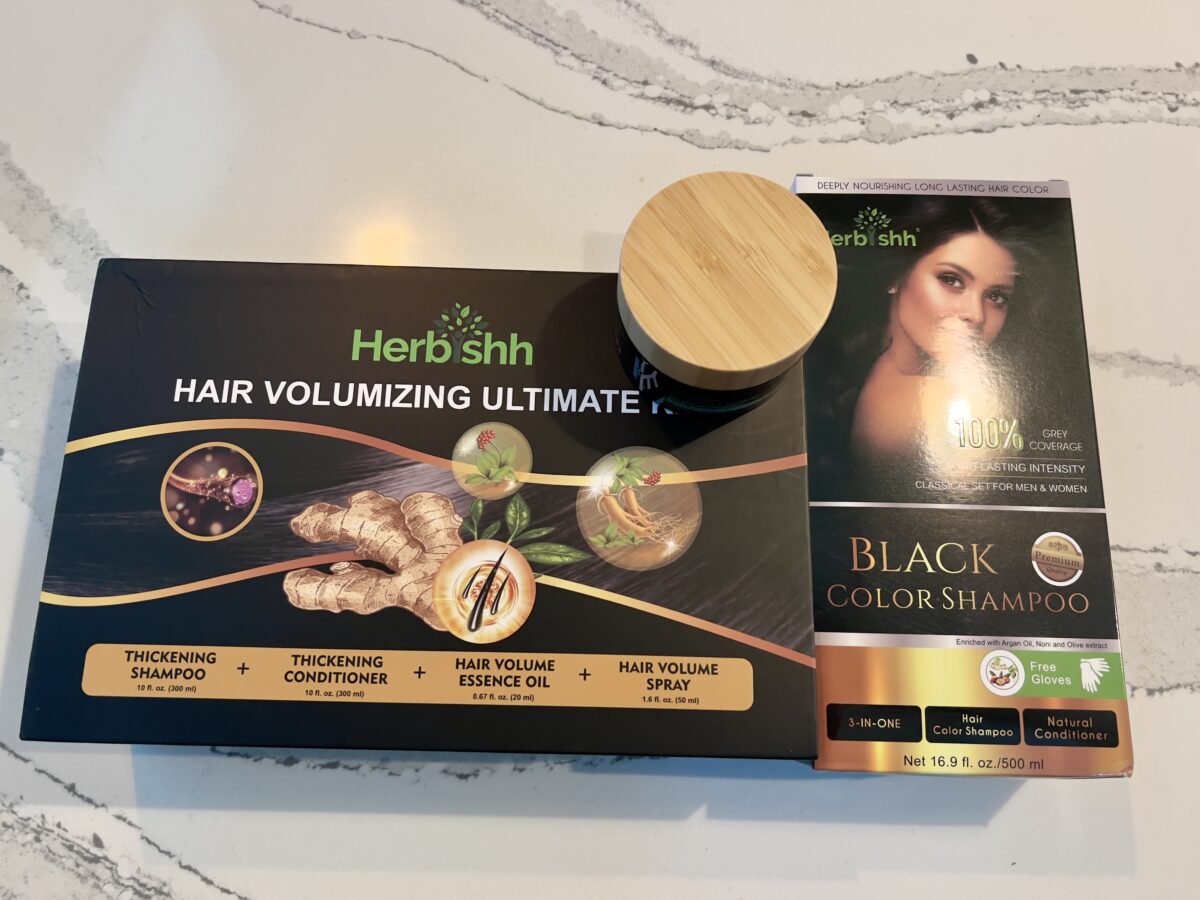The Herbishh Products I am using in this post. The volumizing kit, color shampoo, and hair mask on a white counter top.