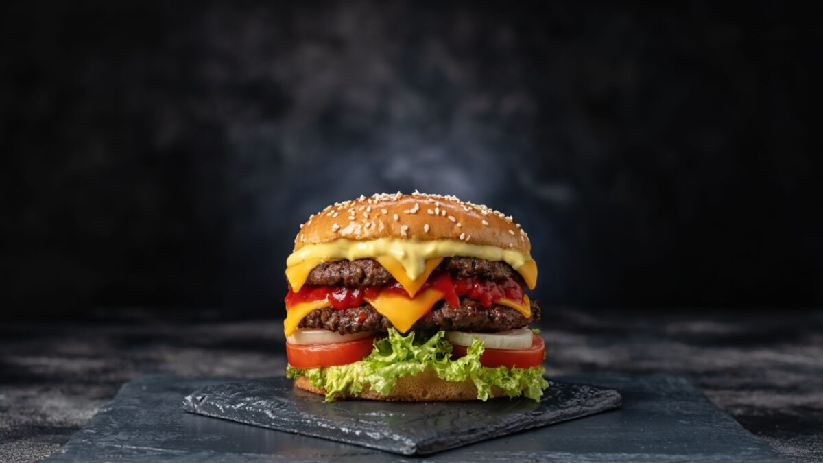 Fresh tasty burger on dark background