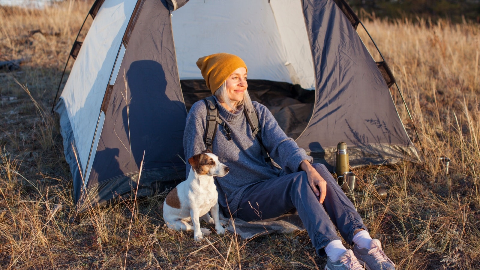 Middle aged woman travel and camping alone at fall forest. Recreation and journey outdoor activity lifestyle.
