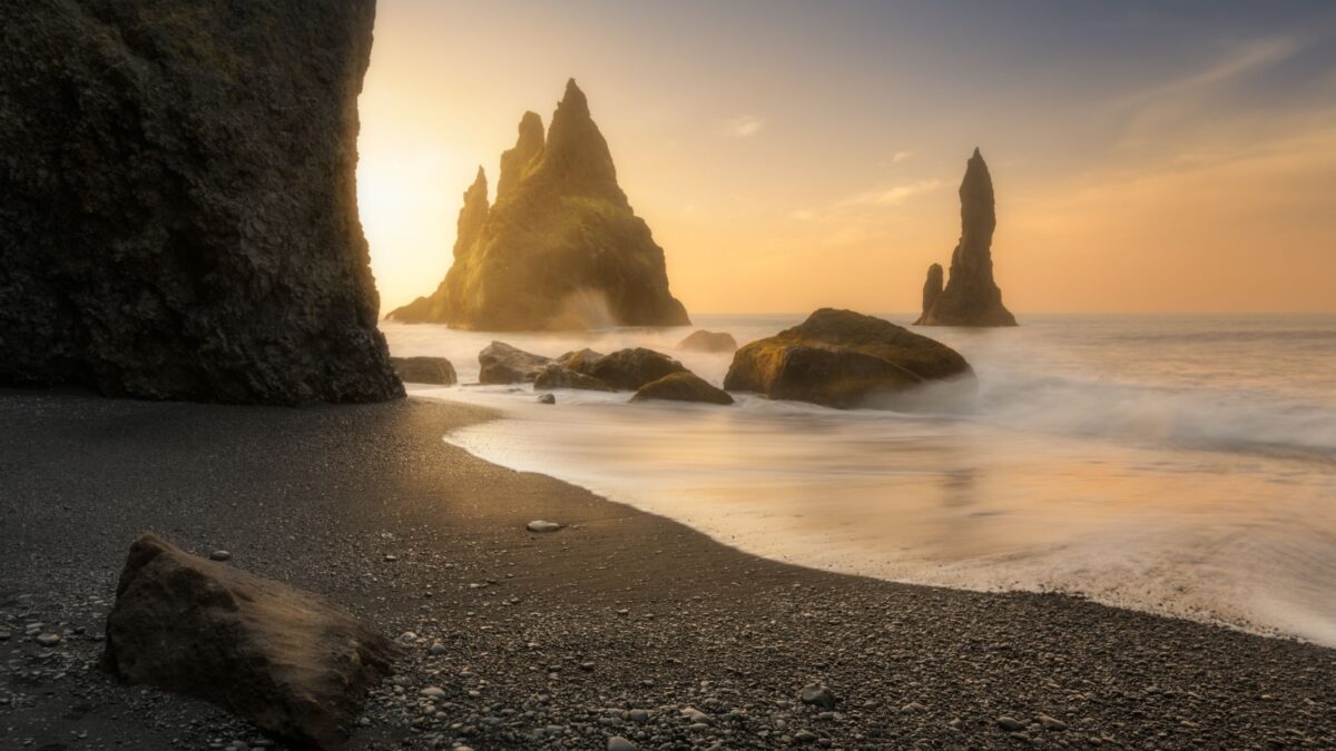 Reynisfjara black sand beach in Iceland, near town of Vik, at sunrise, beautiful basalt rock formation