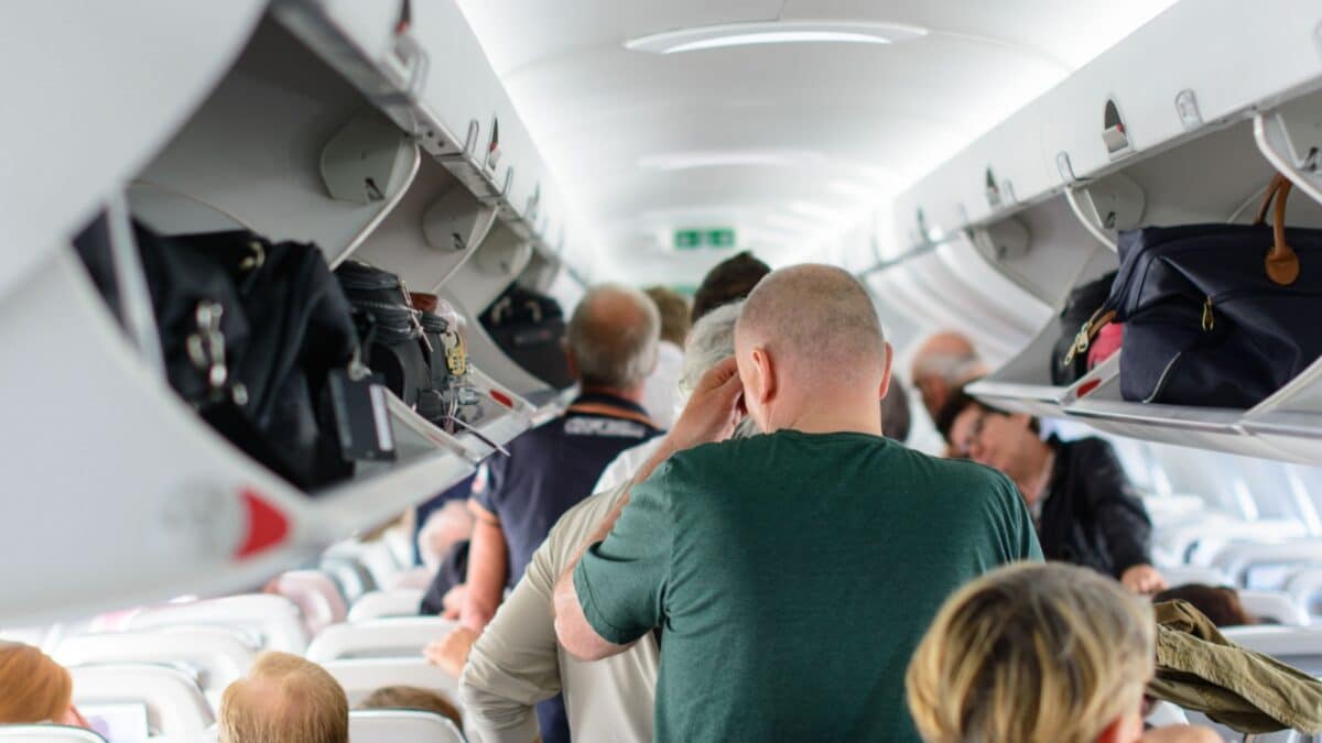 Budapest, Hungary - 25th May, 2017. People are standing and sitting in an airplane cabin before disembarking.
