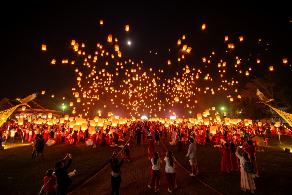 Fire Lanterns Floating up into the sky at night at Loi Krathong Festival Travel Destinations Of Chiang Mai, Thailand. Background of sky fire lantern at night in the Yee Peng Festival at Chiang Mai