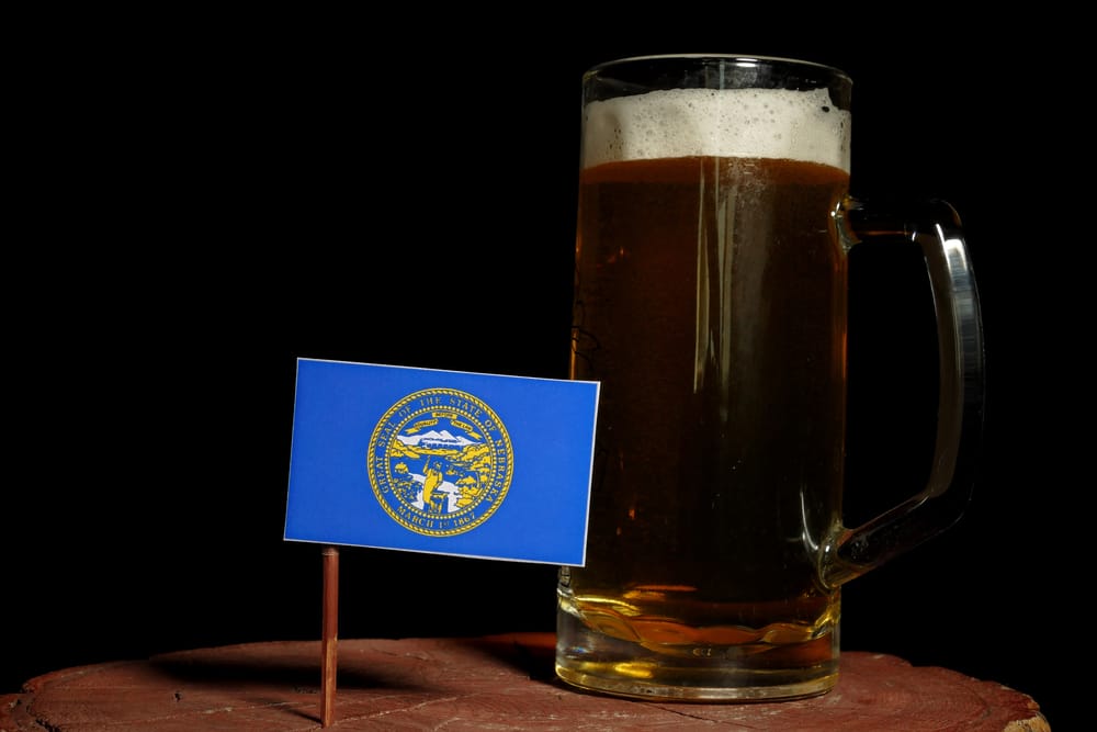 Nebraska flag with beer mug isolated on black background